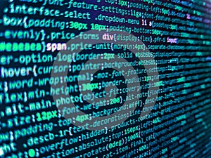 Background of software developer script. Web server data on a monitor. HTML CSS3 source code on lcd screen with black background.