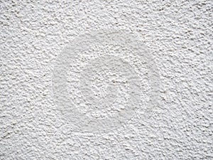 Background from solid material. Pimply white wall. Uneven wall surface