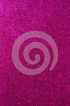 Background with sparkles. Backdrop with glitter. Shiny textured surface. Vertical image. Dark pink