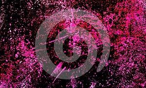 Background with splashed and spots of pink paint on dark background.