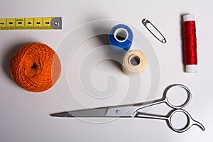 Background of a spool of multi-colored thread and scissors