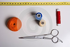 Background of a spool of multi-colored thread and scissors