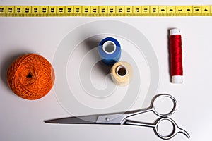 Background of a spool of multi-colored thread and scissors