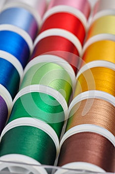 Background from spools with multicolored sewing threads