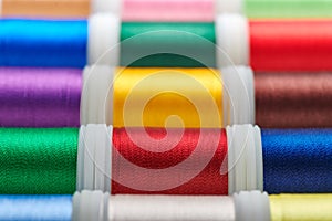 Background from spools with multicolored sewing threads