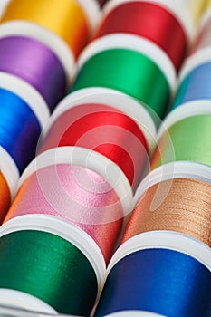 Background from spools with multicolored sewing threads