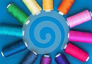 Background from spools of threads of different colors, top view