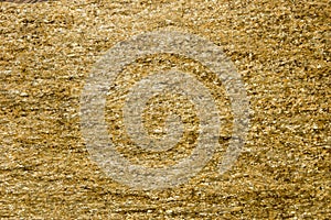 Background of stone with gold flecks. Stone rock with gold particles.