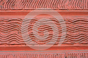 Background stone wall wave. Wall brick red.