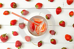 Background of strawberry water and fresh berries on a light white table. Detox, a healthy lifestyle. Top view