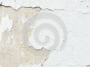 Background, surface texture. a layer of white peeling paint on rough gray concrete, cement, plastered wall.