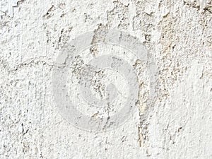 Background, surface texture. a layer of white peeling paint on rough gray concrete, cement, plastered wall.