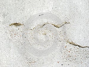 Background, surface texture. a layer of white peeling paint on rough gray concrete, cement, plastered wall.