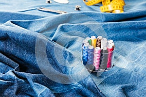 Background table top view of sewing tool and jeans on denim fabric