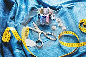 Background table top view of sewing tool and jeans on denim fabric