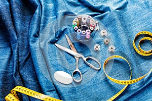 Background table top view of sewing tool and jeans on denim fabric