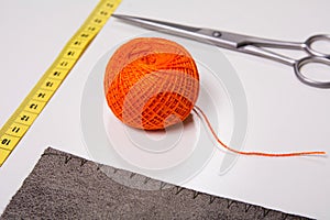 Background for tailor orange thread and sewing tools