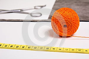 Background for tailor orange thread and sewing tools