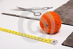 Background for tailor orange thread and sewing tools