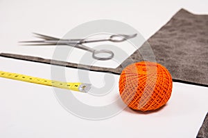 Background for tailor orange thread and sewing tools