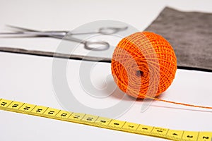 Background for tailor orange thread and sewing tools