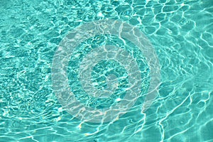 Teal blue pool water with ripples