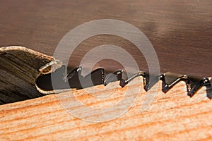 Background of the teeth of two different saws and boards macro