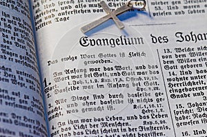 Background with the text from the Bible written in Gothic font and with a silver cross