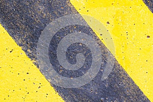 Background or texture Abstract. Top view of Yellow black caution warning lines on concrete floor grunge .