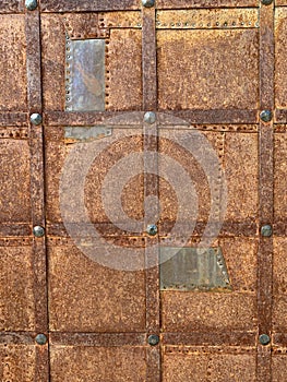 Background texture: ancient metal door. Rusty surface of a medieval door. Entrance gate to the ancient castle