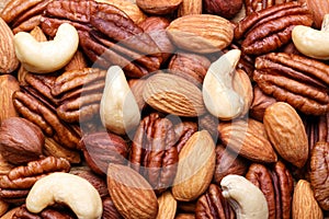 Background texture of assorted mixed nuts including cashew, peca photo