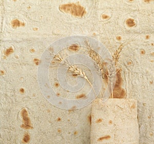 Background texture of baked lavash and ears of wheat