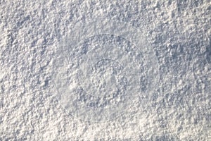 Background, texture of bright white snow on a sunny day
