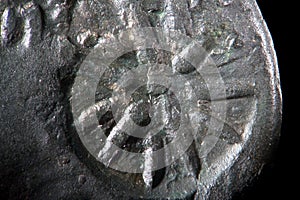 Background texture corroded metal of ancient Greek copper coin. Rough grained surface super macro close-up by microscope