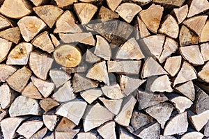 Background texture of split logs in a woodpile