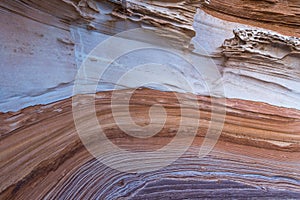 Background texture of eroded sandstone with red layered patterns and curves