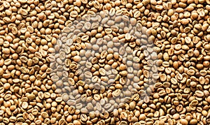 Background texture or fresh raw dried coffee beans