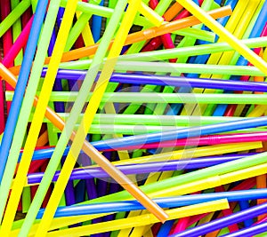 Background texture-jumbled pile of colorful plastic straws
