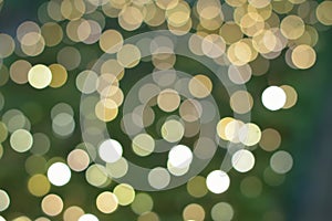 Background texture of green colored Christmas decoration blurred lights