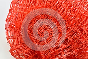 The background and texture of the grid are red.