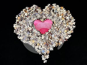 Background texture: heart shape on puzzle paper background. Puzzle in the details in the form of a mosaic. Concept: love,