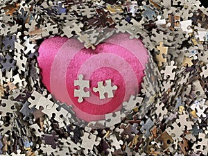 Background texture: heart shape on puzzle paper background. Puzzle in the details in the form of a mosaic. Concept: love,