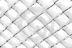 Background texture made of rabitz grid covered with snow.