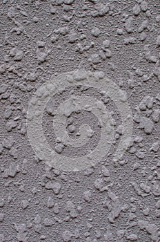 Background, texture of a modern plastered facade of a residential building. Exterior wall cladding machine gray plaster