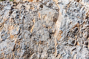 Background and texture of mountain layers and cracks in sedimentary rock on cliff face. Cliff of rock mountain.
