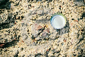 Background texture of nature rock and bottle cap.