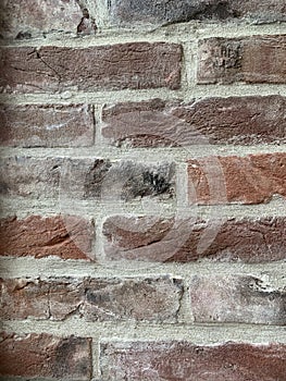 Background texture: old brick wall. Modern interior in loft style, brick partition, close-up. Antique dark red brick