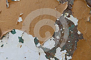 The background texture of the old metal painted surface with cracks, flakes and white, brown and green spots.