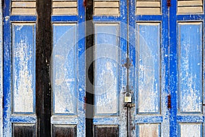 Background texture on old rustic blue wooden folding door of classic Sino-Portuguese architectural style shophouse building