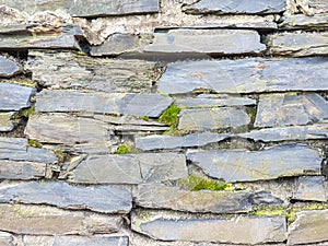 Background texture old wall made of beautiful gray flat stones or bricks